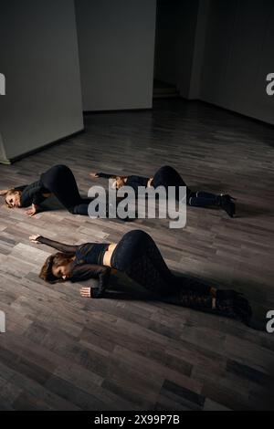 Three high heels dancers practicing floorwork moves Stock Photo