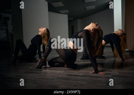 Dancing trio doing high heels floorwork choreography Stock Photo