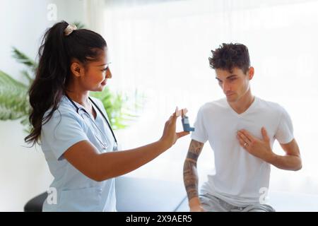 man using inhaler during asthmatic attack with doctor Stock Photo