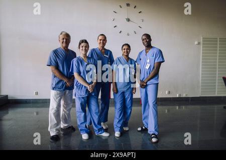 Full length portrait of confident diverse healthcare professionals standing together in hospital Stock Photo