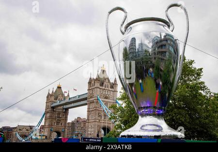 London, UK. 30th May, 2024. Champions League Fanzone at Potters Fields next to Tower Bridge. A giant replica of the Champions League trophy is the centrepiece of the fanzone for the big game which kicks off at Wembley Stadioum at 8pm on Saturday. The Final is between Borussia Dortmund and Real Madrid. A rule introduced in 1968/1969 states that the cup becomes the property of any club who wins the trophy 5 times or three times in a row. Credit: Mark Thomas/Alamy Live News Stock Photo