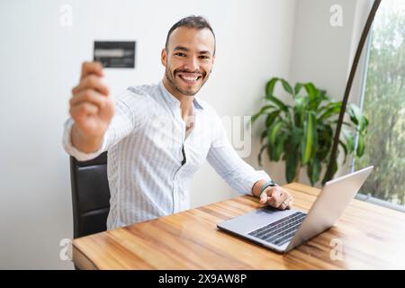 Portrait young mexican attractive businessman working at modern home office with computer laptop Stock Photo