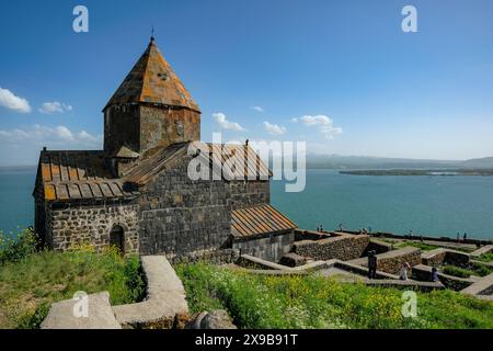 Sevan, Armenia - May 30, 2024: Tourists at Sevanavank Monastery is a monastic complex located on a peninsula at the northwestern shore of Lake Sevan. Stock Photo