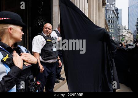 12th June 2023, City of London, UK. Extinction Rebellion 'Oil Slickers' protest fossil fuel funding at Bank of England. Stock Photo