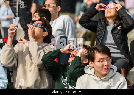 Viewers watch the solar eclipse of 2024 from the lawn of the Vermont State House, Montpelier, Vermont, USA, April 8, 2024. Stock Photo