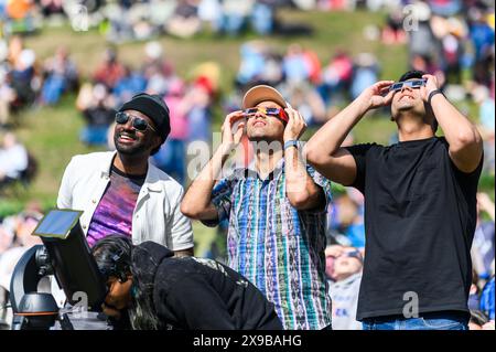 Viewers watch the solar eclipse of 2024 from the lawn of the Vermont State House, Montpelier, Vermont, USA, April 8, 2024. Stock Photo