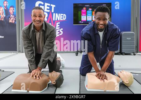 London, UK. 30th May, 2024. Dutch football legend Ruud Gullit and fellow UEFA Champions League winner Mikel John Obi (also known as John Obi Mikel) perform CPR on a dummy at the ‘Get Trained, Save Lives' UEFA CPR campaign booth at Potters Fields Park, part of the free UEFA Champions Festival for fans and visitors. Credit: Imageplotter/Alamy Live News Stock Photo