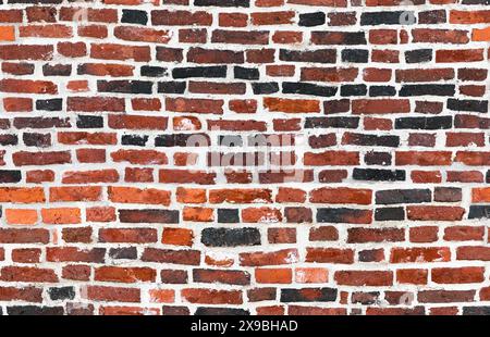 Ancient brick wall with red and black bricks and white concrete, seamless background photo texture Stock Photo