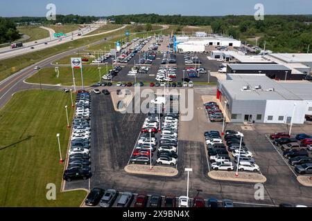 Jackson, Michigan - New car dealers along Interstate 94. From bottom: Nissan, Chrysler, Honda, and Chevrolet vehicles on sale. Stock Photo