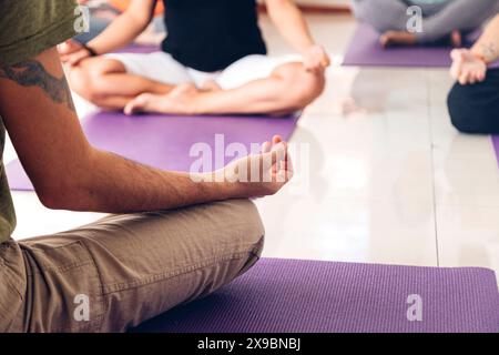 Yogi people practice yoga in lotus position. Meditation in group. Stock Photo