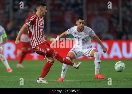 ATHENS, GREECE - MAY 29: Stevan Jovetić of Olympiacos FC shoots in front of Rolando Mandragora of ACF Fiorentina during the UEFA Europa Conference League 2023/24 final match between Olympiacos FC and ACF Fiorentina at AEK Arena on May 29, 2024 in Athens, Greece.(Photo by MB Media) Stock Photo