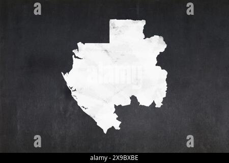 Blackboard with a the map of Gabon drawn in the middle. Stock Photo