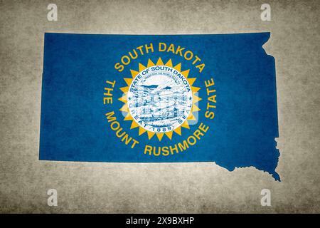 Grunge map of the state of South Dakota (USA) with its flag printed within its border on an old paper. Stock Photo