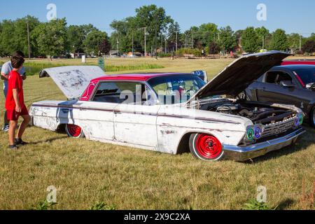 A white and red 1962 Chevrolet Impala lowrider on display in a car show at Riverside Gardens Park in Leo-Cedarville, Indiana, USA. Stock Photo