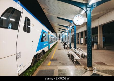 a white and blue regional train at Ljubljana Railway Station, Slovenia, at night Stock Photo