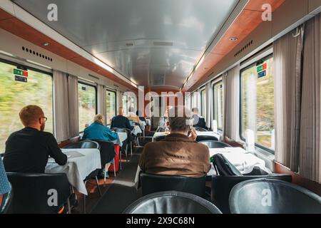 Passengers in the dining car on an ÖBB Austrian Railways Eurocity train from Slovenia to Austria Stock Photo