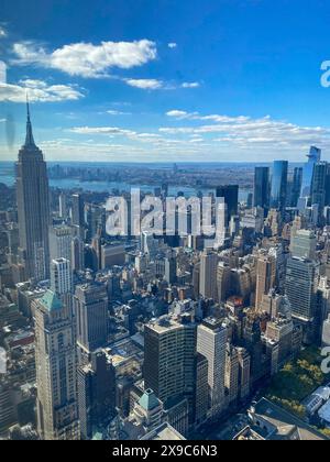 New York skyline in daylight, the Empire State Building is striking under a cloudy sky, new york from above with impressive skyscrapers and clouds in Stock Photo