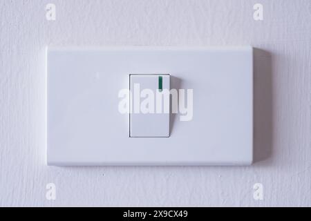 room light switch on white concrete wall Stock Photo