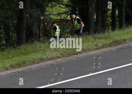 File photo dated 9/7/2015 of police officers searching the scene at Junction 9 of the M9 after a car was discovered. A crashed car lay undiscovered for days with two people inside after an 'organisational failure' in police call handling procedures, a fatal accident inquiry has found. The inquiry also found a police officer who failed to log a call reporting the incident was inadequately trained. Lamara Bell, 25, and John Yuill, 28, died after the car they were in left the M9 near Stirling on July 5, 2015 as they drove back from a camping trip. Issue date: Friday May 31, 2024. Stock Photo