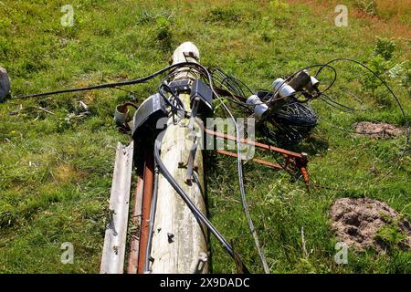 A roadside casualty of a driving accident with a heavy vehicle having hit a telegraph pole and snapped it knocking the top part over. Stock Photo