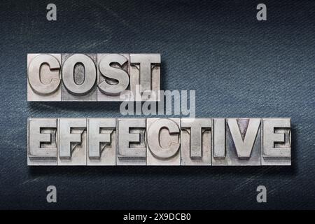 cost effective phrase made from metallic letterpress on dark jeans background Stock Photo