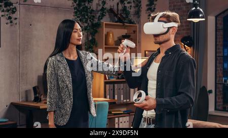 Television Sitcom Living Room: Couple Has Relationship Problems. Funny Sketch About Guy Having VR Metaverse Addiction, Girl Confronts Him. Comedy Show on Network Channel, Streaming Service. Stock Photo