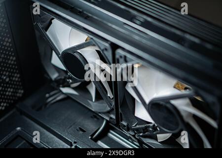 Close-up view of two computer cooling fans inside a PC case, highlighting the fan blades and mounting. Stock Photo