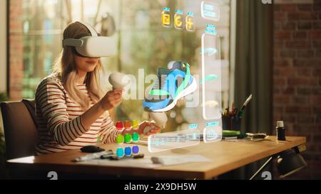 Talented Female Shoes Designer Wearing Virtual Reality Headset and Using Controllers to Design a Fashionable Sneaker in Augmented Reality Software. Woman Working on Digital Footwear at Home. Stock Photo