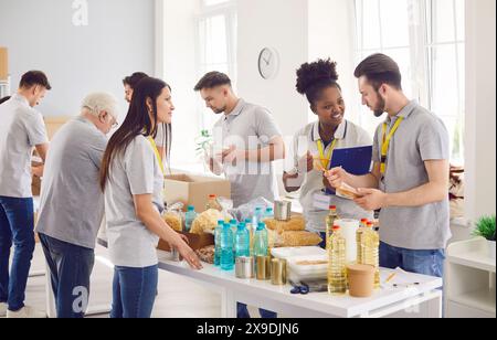 Diverse caring volunteer group working in charitable food foundation, make donation to needy Stock Photo