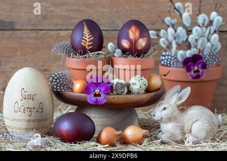 easter decoration with coloured eggs with leaf ornament and easter bunny Stock Photo