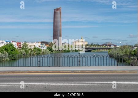 The Torre Sevilla and Torre Triana buildings seen from the Isabel II bridge in Seville, Spain Stock Photo