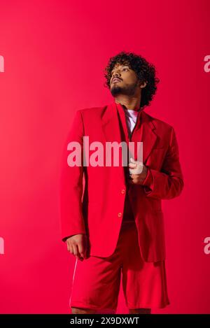 Handsome young Indian man in a striking red suit, exuding confidence and style. Stock Photo