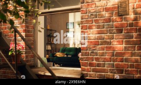 Emtpy and Stylish Loft Apartment with Modern Furtiture and Abstract Art Pieces on the Wall. No People in Cozy and Comfotable Flat With Sun Shining Inside. Shot Throught Apartment Window. Stock Photo