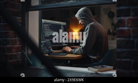 Single-Minded Professional Programmer Obsessively Writing a Code on His Desktop Computer, Late at Night. IT Specialist Ethical Hacker Working on Computer and Finding Software Vulnerabilities. Stock Photo