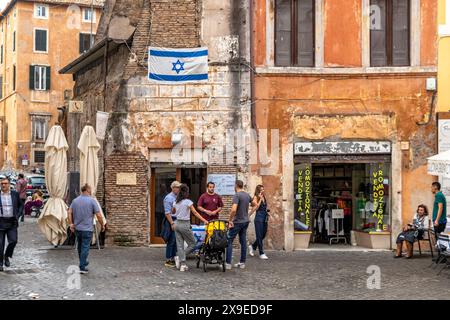 A group of people having a conversation on Via del Portico d'Ottavia in The Jewish Quarter of Rome,Italy Stock Photo