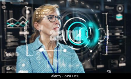 Adult Female Engineer Using Futuristic Augmented Reality Software Interface for Managing Data Center Work Projects. Specialist Researching Complex Performance Data Graphs with Different Parameters. Stock Photo