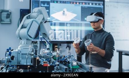 Computer Science Engineer in Virtual Reality Headset Using Controllers and Operating Robot Arm Under his Control. VFX Augmented Reality Icons Demonstrate Innovative Technologies Concept. Stock Photo