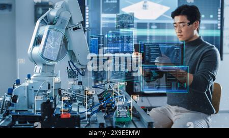 Computer Science Development Engineer Using Tablet Computer to Program and Operate a Robot Arm. VFX Augmented Reality Interfaces and Icons Demonstrate Innovative Industry 4.0 Concept. Stock Photo