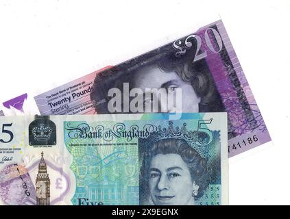 Close up of a modern twenty pound Scottish polymer banknote and a five pound banknote from the United Kingdom on a white background. Stock Photo