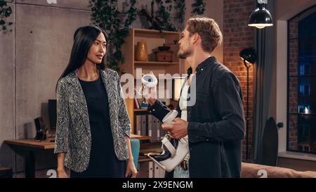 Television Sitcom Living Room: Couple Has Relationship Problems. Funny Sketch About Guy Having VR Metaverse Addiction, Girl Argues with Him. Comedy Show Broadcast Network Channel, Streaming Service. Stock Photo