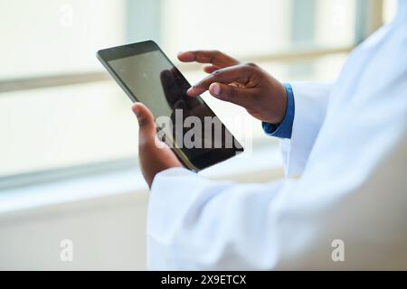 Close-Up of Doctor Using Digital Tablet in Modern Hospital for Patient Care Stock Photo