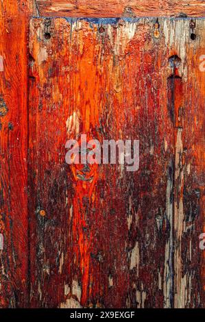 Background of a red wooden panel made with rustic wood. Stock Photo