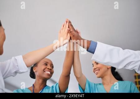 Diverse Medical Team Doing High-Five in Hospital Setting Stock Photo