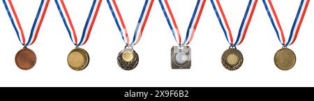 Collection of sports medals of various materials and designs with blue white and red ribbon isolated on white background. Stock Photo