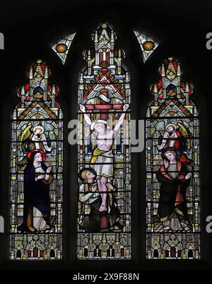 A stained glass window by Lavers, Barraud & Westlake depicting the Crucifixion of Jesus, Holy Trinity Church, Stourpaine, Dorset Stock Photo