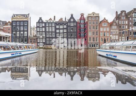 The famous Dancing houses of Damrak pictured in Amsterdam, the Netherlands on 29 May 2024 between two long river cruises. Stock Photo