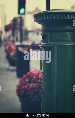 Close-up of a tree Mailbox in street next to flower planters, Kilkenny, County Kilkenny, Ireland Stock Photo