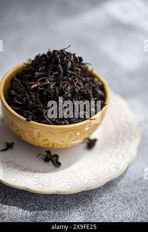 Close-up of a Ceramic bowl filled with loose leaf tea on a table Stock Photo