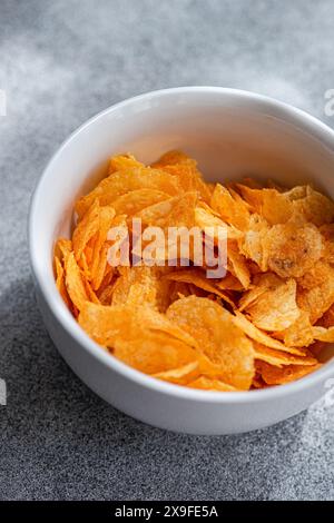 Close-up overhead view of a bowl of paprika crisps Stock Photo