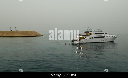 A dive boat enables scuba divers to explore coral reefs and wrecks in the Red Sea on an evening dive. Stock Photo